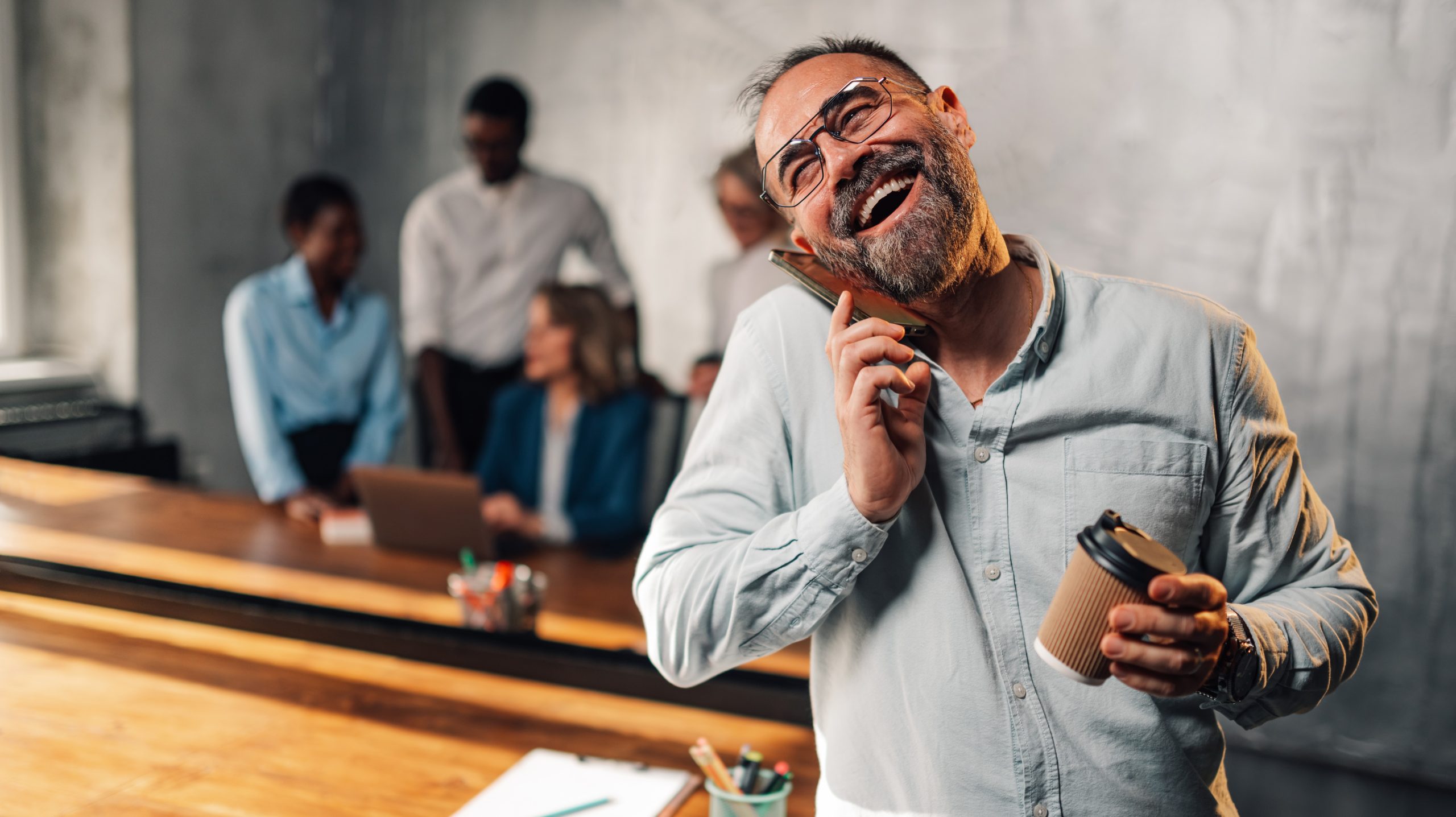 laughing-mature-male-leader-having-phone-call